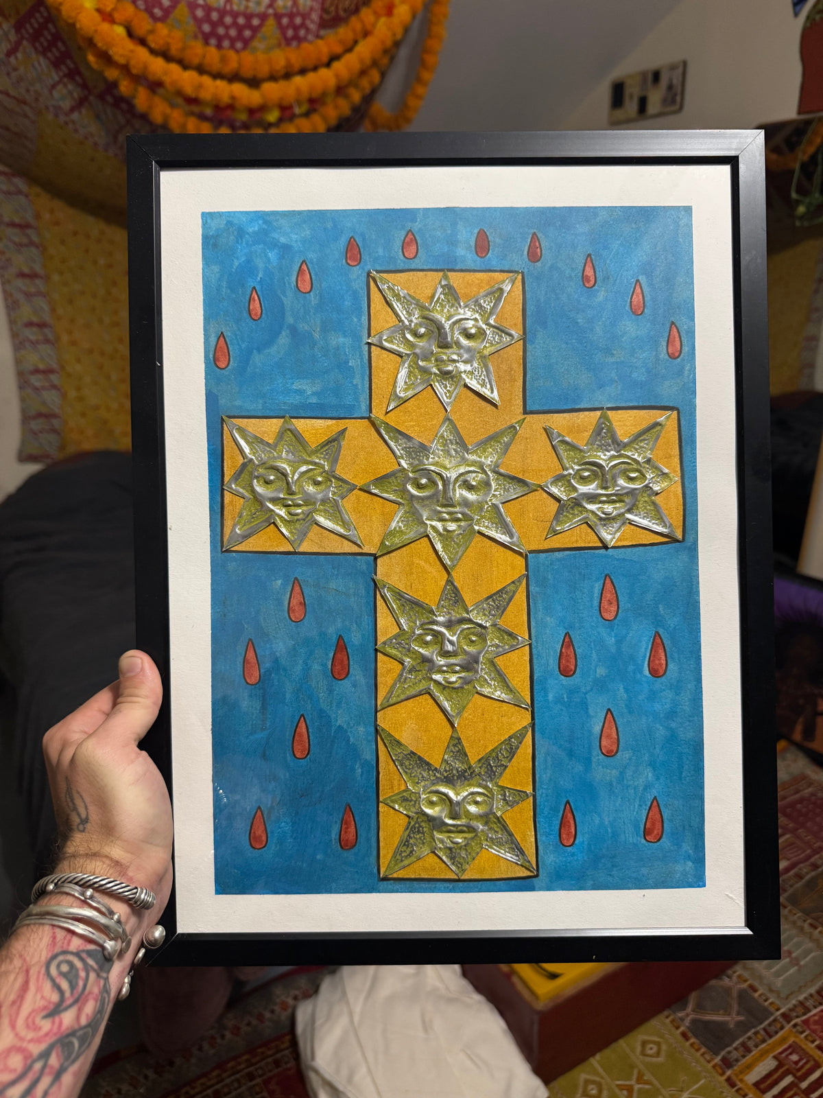 Framed yellow geometric cross and fish against a blue background