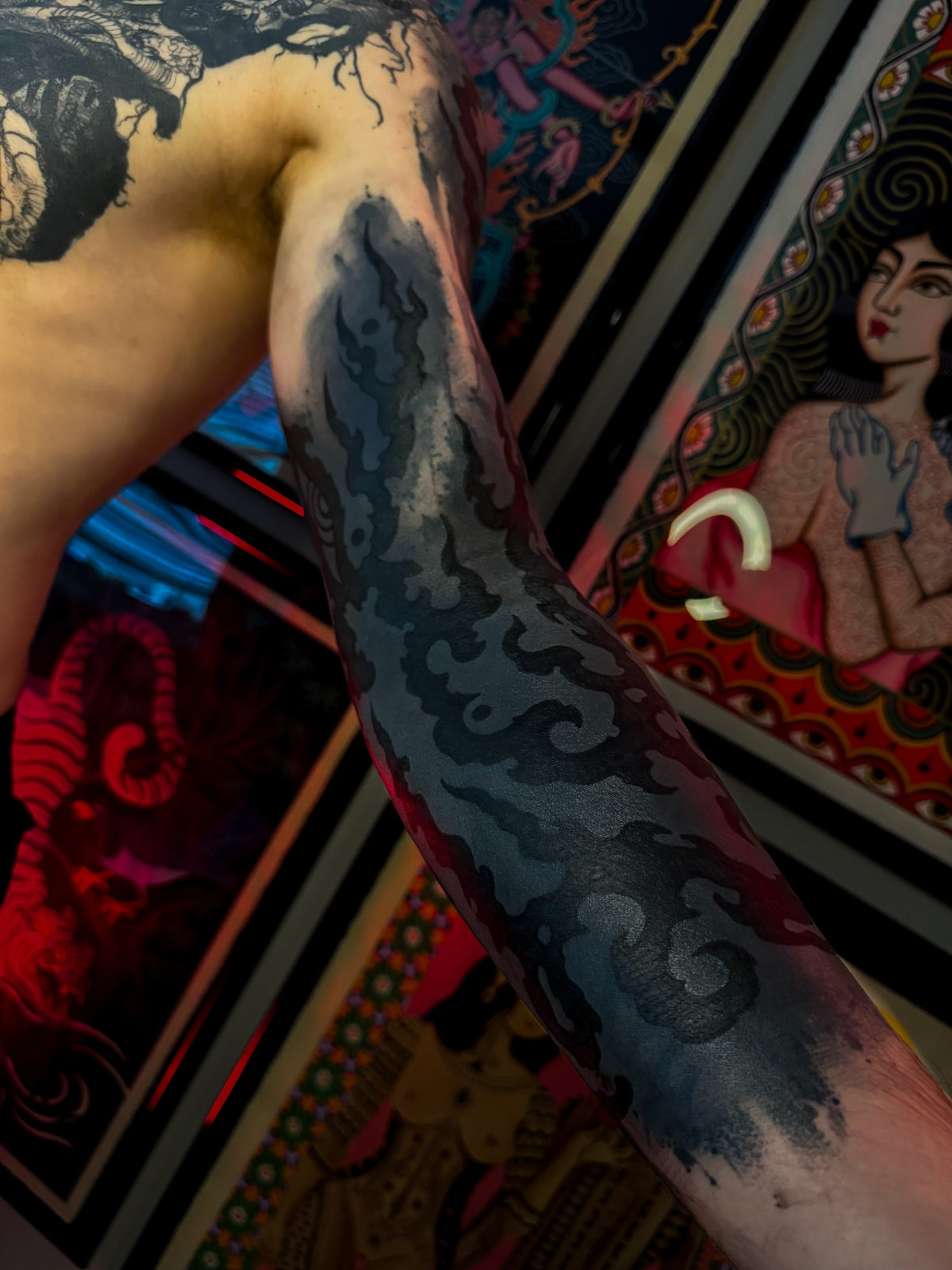 Flowing ornamental arm tattoo